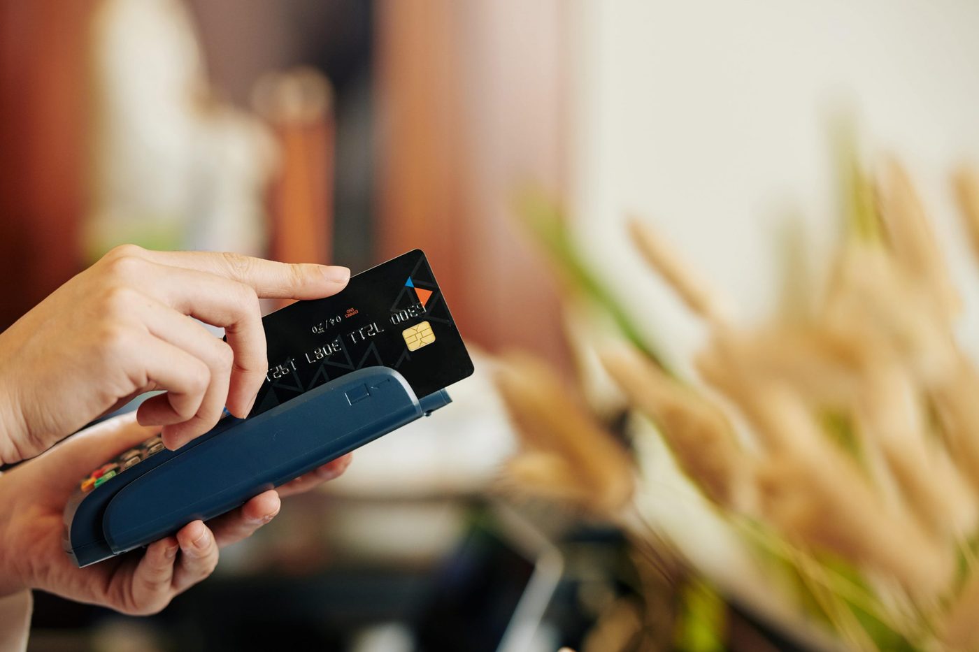 Fanned payment cards beside a POS terminal